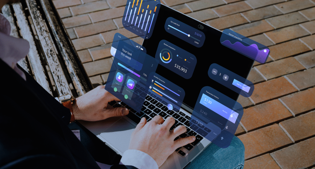 Close-up of a person's hands on a laptop keyboard with floating digital widgets showing bar graphs, pie charts, and connectivity icons, symbolizing the integration of SaaS tools into business automation.