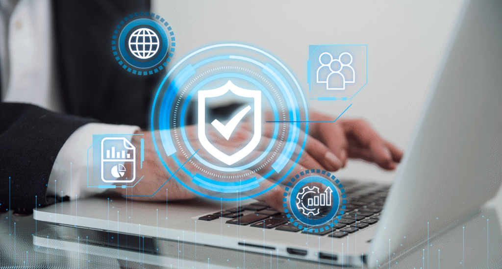 A professional using a laptop with a glowing shield and checkmark hologram, symbolizing the 2026 SaaS trend of proactive data security and Zero Trust architecture to build user confidence in cloud platforms.